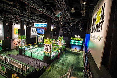 A miniature football field and stadium seating were set up on the lower level of the Puppy Bowl experience. Guests snacked on bags of popcorn and desserts as the dogs engaged in live play.