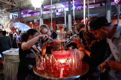 A central highboy table held a glowing punch fountain, which servers ladled into plastic cups.