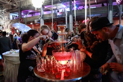 A central highboy table held a glowing punch fountain, which servers ladled into plastic cups.