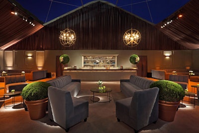 The event's design felt modern and architectural, with structured seating in rich upholstery.