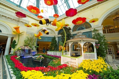 The Bellagio Conservatory & Botanical Gardens’ spring 2012 exhibit had a Dutch village theme with a rotating windmill and a floral exhibition showcasing tulips, azaleas, hibiscus, and lilies. A carousel, waterfall, and ceiling-hung hand-painted parasols completed the look, while live harp and violin performances added to the experience.