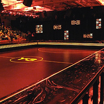 The runway, a raised platform topped with black plexiglass, wrapped around three sides of the court of the Hunter College gymnasium. Guests sat on opposite sides, squeezed into padded bleachers.