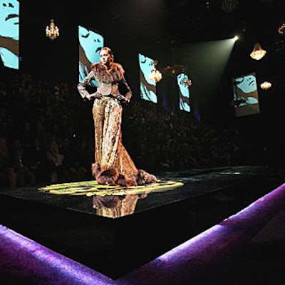 Thirty chandeliers of varying sizes hung at different lengths and were raised and lowered throughout the show. The house went completely black in the moments prior to the brand’s presentation.