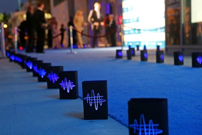 Paper Acorn created the luminaries, which lined the carpet leading to the arrivals area and bore the symphony's logo, as well as the table numbers.