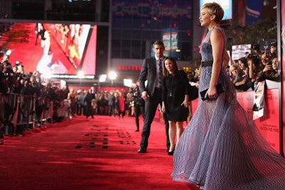 Security staff guarded Jennifer Lawrence on the red carpet at the U.K. premiere of The Hunger Games: Catching Fire.