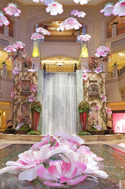 For its spring 2013 installation, the Palazzo Las Vegas suspended 60 floating cherry blossoms from the glass dome in the Waterfall Atrium, making it look like the pieces were falling from a tree. The sun passed through different positions throughout the day, offering different shades and shadows—and photo ops for guests. The waterfall and infinity pond complemented the falling blossoms, and knotted grape vines (recycled from fall decor) along with cherry blossoms added to the branches to give a Japanese feel to the gardens.