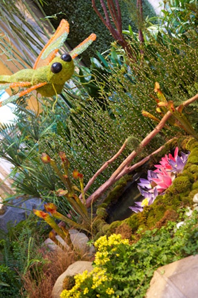 For Summer 2011, the Waterfall Atrium at the Palazzo Las Vegas was transformed into a bog garden. It featured three hand-sculpted frogs that sat in the center of the water feature, accented by water lilies, cobra lilies, mosses, ferns, and water reeds. Whimsical jeweled dragonflies dotted the gardens in vibrant oranges, hot pinks, and chartreuse greens.