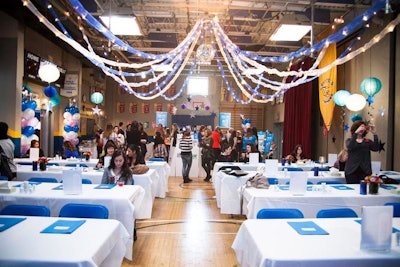 Colorful bunting and twinkle lights hung overhead, giving the space a prom-inspired look. Bunches of blue and white balloons were scattered throughout the space.