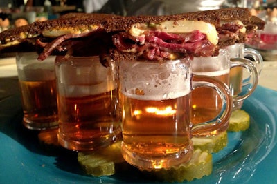 As part of its 'Sip & Taste' concept, which pairs snacks with beverages, Wolfgang Puck Catering offers pastrami sandwiches made with American Waygu beef and Russian dressing. The hearty bites are presented atop miniature mugs of Anchor Brewing Company’s Liberty Ale.