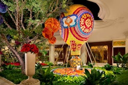 The hot-air balloon stands 20 feet tall and weighs 4,000 pounds, while the carousel is 13 feet tall, 16 feet wide, and weighs 6,000 pounds. Both installations feature theatrical lighting and are accompanied by festive music. Bailey said he looked to childhood inspirations to complement the existing whimsical theme of the Wynn atrium.