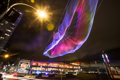 Artist Janet Echelman and Google Creative Lab's Aaron Koblin installed an eye-popping aerial sculpture at the TED Conference in Vancouver. The sculpture was suspended 745 feet between the 24-story Fairmont Waterfront and the Vancouver Convention Center for an unmissable visual centerpiece more than twice the size of the artist's largest previous sculpture. Passersby could use their cell phones to control the piece's lighting, which was provided by Graphics eMotion and Kinetic Lighting.