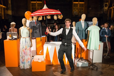 With circus-style acts—dressed in items from the new line—performing throughout the space and displays placed on carts and bright orange-colored blocks, the catering for Ted Baker's Spring/Summer 2014 collection launch event provided an additional visual and entertainment element. For instance, parasols held dangling funnel cakes, and servers were trained to imitate tightrope walkers as they passed the bites.