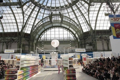 The 139,930-square-foot show space was a veritable Costco for the moneyed set, stocked with everything from Chanel-branded chain saws and door mats to cheeses, meats, and household paint. Guests were seated in the four corners of the faux supermarket with each area offering a different perspective of the venue.