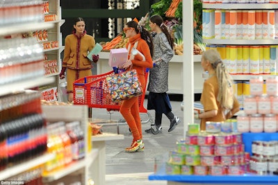 As models emerged wearing the latest Chanel designs, they casually perused and shopped the aisles. It took approximately 4.5 minutes for each model to walk the entire zigzag of the runway. Some even pushed the customized carts, plucking products off the shelves as they walked.