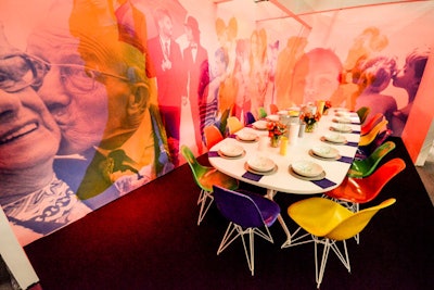The Gensler and Herman Miller vignette was titled “XO—Celebrating 30 Years of Caring.” Colored lighting changed the custom wall covering, altering the scene and pushing certain elements forward, while colorful chairs were complemented by a clean setting atop a white table.