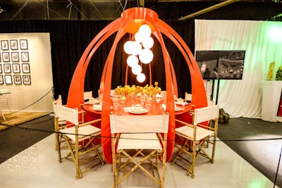 Playing with the concept of self-contained tables, Marc Blackwell New York’s table had its own light source, live items on the table, and open wine. Blackwell’s “table as a unit” concept was enclosed by a lacquer structure cast in Diffa's signature red; from afar the piece looked like a budding flower.