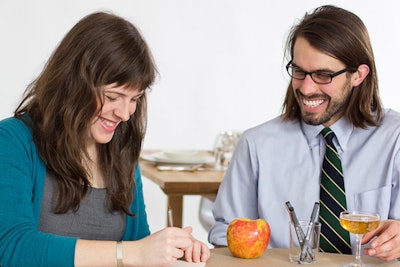 Illustrator Jana Kisman sits with guests at a table and quickly sketches flattering caricatures.