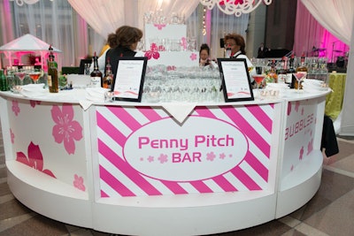 The Penny Pitch bar had guests toss tokens into one of four glasses in a pyramid at the center of circular bar. The glass—a martini, highball, champagne, or wine glass—determined the guest’s cocktail and served as a souvenir from the party.