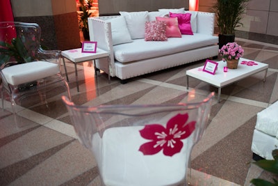 Additional lounge groupings of white and Lucite sofas, chairs, and ottomans provided seating for top sponsors.