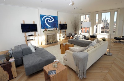 Time Warner Cable held a national press event in 2010 to introduce its all-in-one service package SignatureHome. To illustrate how the products work in various environments, the cable company created a temporary home for the launch in a three-story New York town house and styled five rooms to represent different areas of the home. The first floor of the home was set as a living room, where a painting of the brand's logo decorated one of the walls.