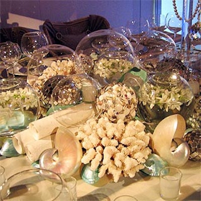 At the Design Industries Foundation Fighting AIDS' Dining by Design benefit, designer Todd Moore created an Atlantis theme for fabric company Schumacher's table. He put several transparent globes filled with shells, water and flowers in the center, beneath a silver tower topped with a statue of Poseidon.