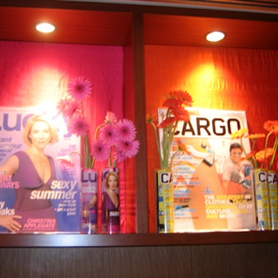 At the Lucky/Cargo Club, an Upfront Week hospitality suite presented by the two shopping magazines at Le Parker Meridien, gerbera daisies in vases lined with magazine covers provided color and easy branding.