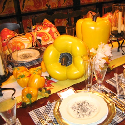 Jamie Drake’s table for Baker furniture juxtaposed black and white checkered napkins and placemats with a Pucci-style bright yellow, orange, and red print on the chair pillows.