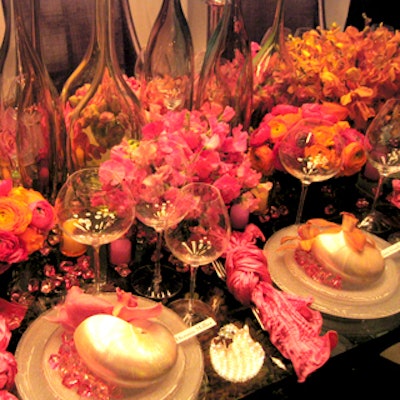 At the Design Industries Foundation Fighting AIDS' Dining by Design benefit, Elaine Griffin's table for the New York Design Center had a clutter of branches decorated with lit orbs and fake monarch butterflies strewn overhead, grass underfoot, nautilus shells with a nacre finish on each plate, and a cluster of long-necked glass vases on the table.