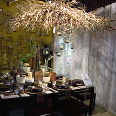 Hanging above the Crate & Barrel table was an umbrella frame covered with curving branches and an upside down fabric umbrella.