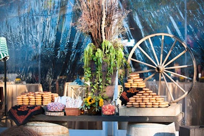 A dessert table included Krispy Kreme doughnuts and wagon wheels as decor.
