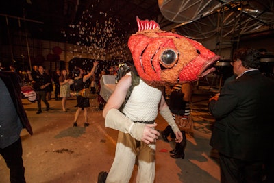 General admission was $450, and all guests got to take in Redmoon's particular brand of surrealistic entertainment. One such spectacle was a performer strolling in a new fish mask created by a Redmoon artist. The 'fish' left a thick trail of bubbles in its wake.