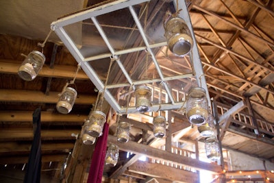 The Midnight Moon Moonshine Saloon at Willie Nelson’s Heartbreaker Banquet in Luck, Texas, took over the town’s opry house and created a rustic atmosphere. Mason jars weighted with sand and candles were suspended over the bar and strung from hanging window frames.