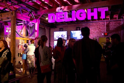 A purple color scheme blanketed Yahoo’s weeklong takeover of Brazos Hall and was used in everything from the uplighting to the plexiglass panels behind the stage. Organizers used large signage with Yahoo typography to divide the space into distinct sections and streamline the user experience of its products. In one corner, Humans of New York photographer Brandon Stanton’s work was exhibited on the venue's existing structure.