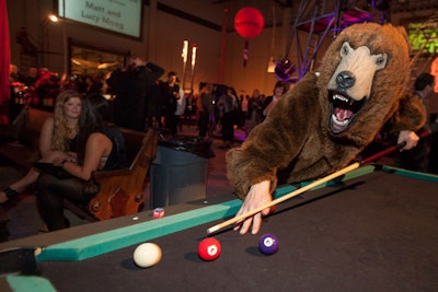 A costumed bear nodded to the theater's upcoming spring spectacle, 'Bellboys, Bears, and Baggage.' At the event, guests could bid $50 to play pool with the bear. Those who beat the bear at the game won a six-pack of beer.