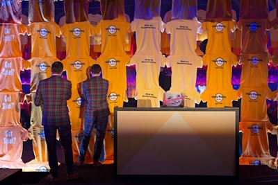 The T-shirts were even used to create a wall between the dinner area and cocktails; the colors and slogans provided the tactile and whimsical backdrop for the DJ booth where duo Andrew Andrew spun tunes for guests.