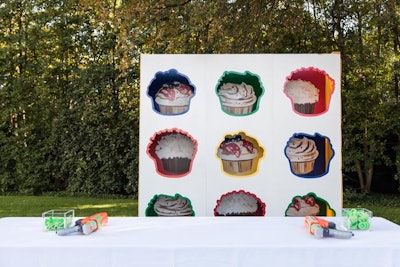 Guests had to win their dessert—a Sprinkles cupcake—by shooting a toy dart gun into the cupcake cutouts.