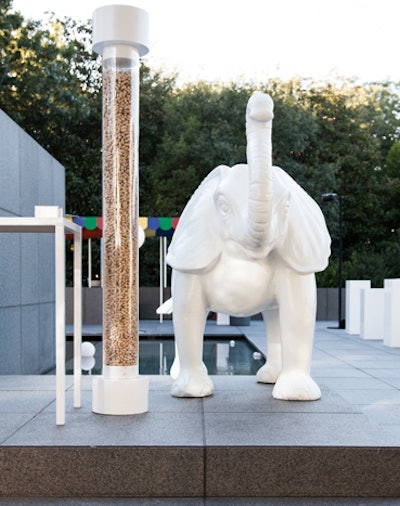 One of the games asked guests to estimate the number of peanuts in an eight-foot-tall tube (answer: about 73,000). Two fabricated elephants flanked the tube.