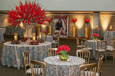 The paisley pattern carried over into linens that covered tables in the seating area, where Bruce's Gourmet Catering provided snacks. The event's gilded chairs and bright red flowers had a sense of presidential pomp that mirrored the premise of the show. Gold was the accent color and appeared in everything from pedestals and banquettes to centerpiece vessels and even the vests and ties on waitstaff.