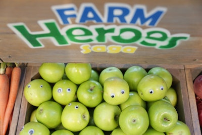 The characters in Farm Heroes Saga are fruits and vegetables, playfully represented at the event with googly eyes stuck on green apples.
