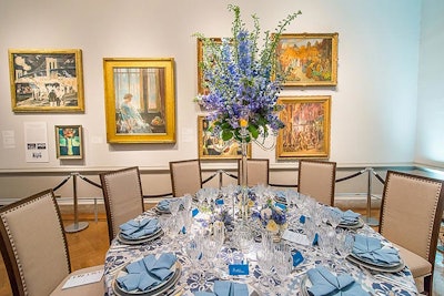 Tall floral arrangements of blue iris atop a glass candelabra allowed guests to talk easily across the table.