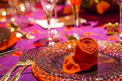 Orange napkins folded like rosebuds topped each of the plates.