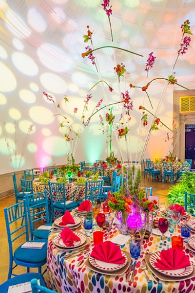 Jack Lucky took a more sparse approach to the centerpieces in one room, adhering single stems to tall, clear plastic rods in a vase.