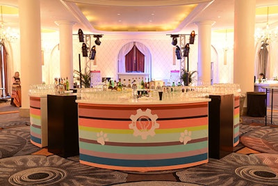 Design Foundry wrapped the reception bar in a striped design combining its logo with the event logo and paw prints.