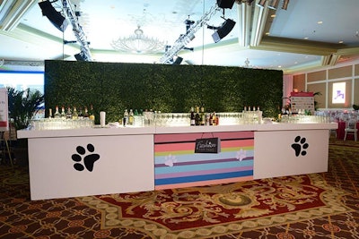Inside the main entrance to the ballroom, another bar had a grass wall backdrop.