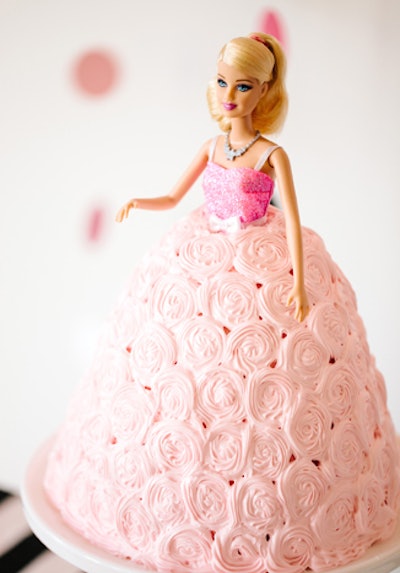 The birthday party had a cake that included a Barbie doll and an edible skirt.