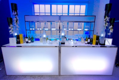At a glowing bar, mixologists served 'electric' theme drinks.