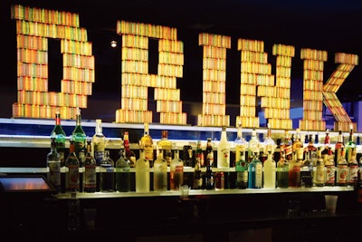 An illuminated “Drink” sign was constructed using thousands of crayons. After the party, the books and coloring supplies were donated to local charities.