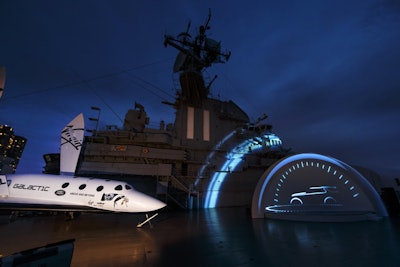 To mark the occasion, a full-size replica of Virgin Galactic's SpaceShipTwo rocket plane was unveiled alongside Land Rover's Discovery Vision Concept S.U.V. Both were parked on the top deck of the Intrepid; prior to its reveal, the Discovery Vision Concept S.U.V. sat behind a tented platform stage that was made as a bespoke item for the vehicle.