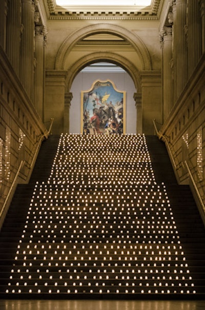 A display of 1,200 votive candles lined the stairs in the Great Hall at the Metropolitan Museum of Art and was one of the first visuals the 900 guests encountered as they arrived from the St. James Theatre for the opening night party for Bullets Over Broadway.