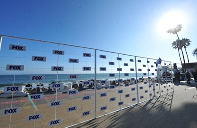 Fox's Television Critics Association party at Los Angeles's Gladstone's in 2011 took full advantage of the beachy Malibu location. The press wall—a powder-coated steel frame and cable with a grid of floating Fox logos—allowed the beach and ocean behind it to become a part of the photo backdrop.